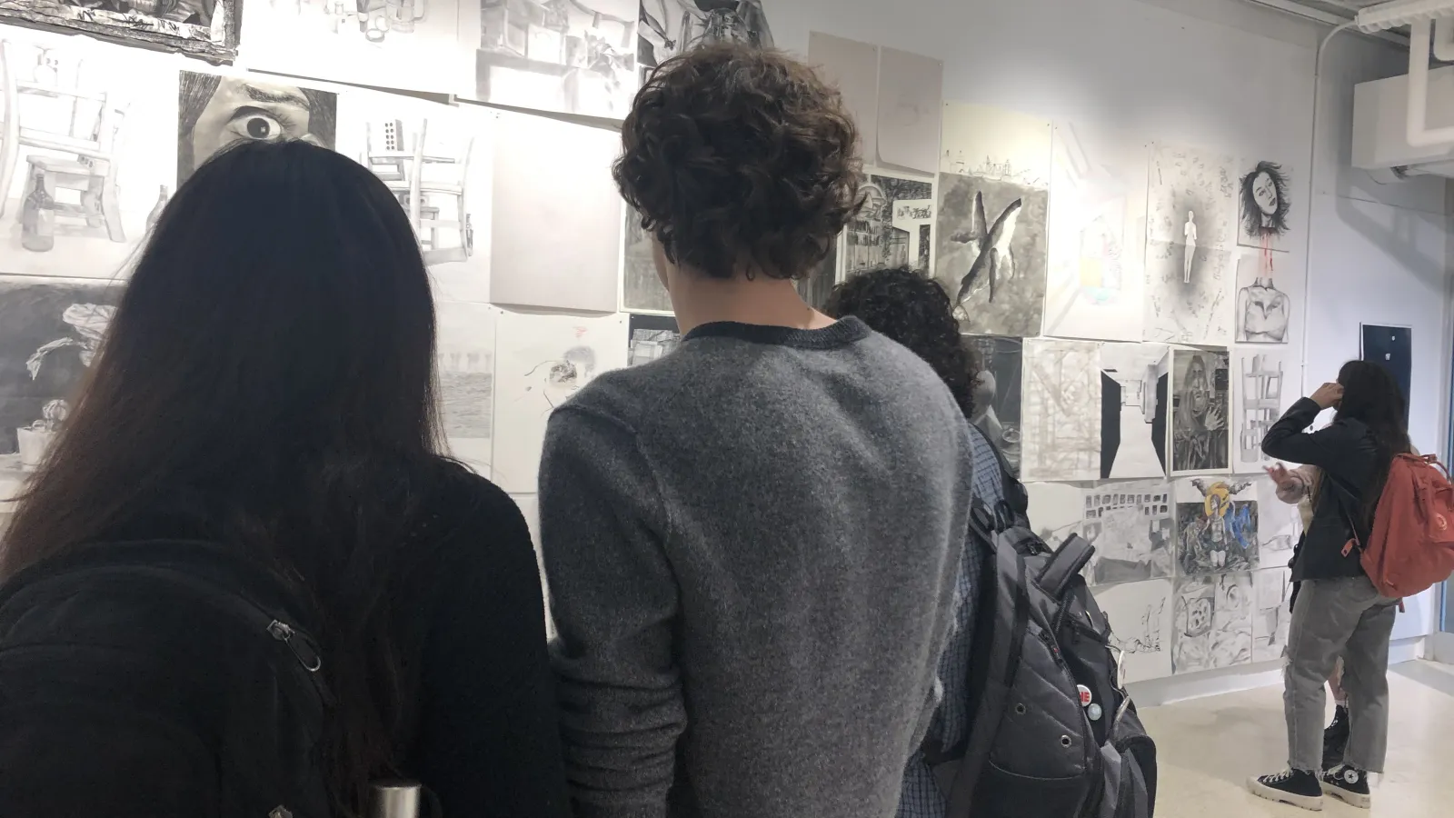 students observing other's artwork