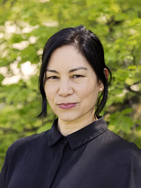 a person with dark hair and eyes wearing a black shirt