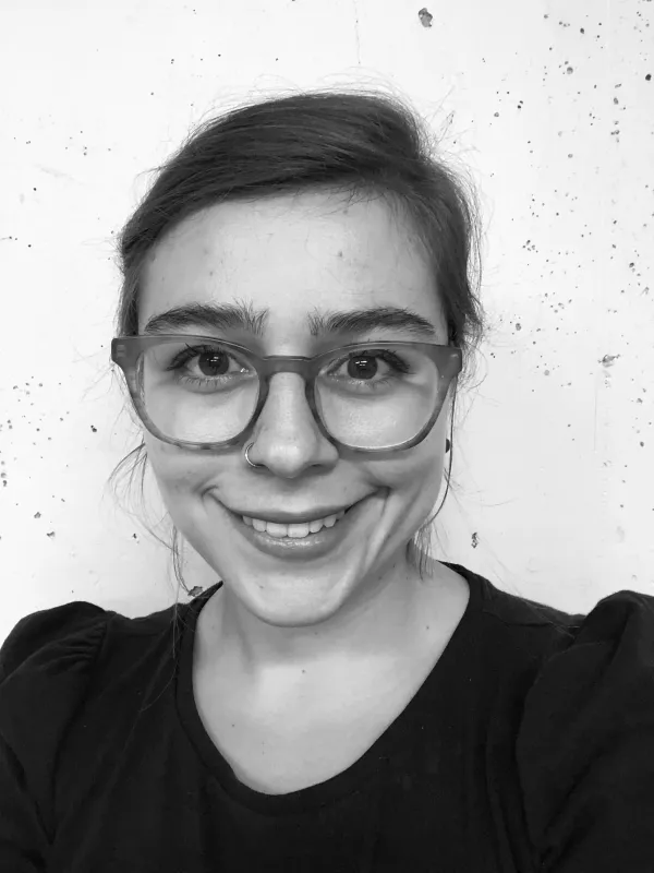 a smiling person with glasses