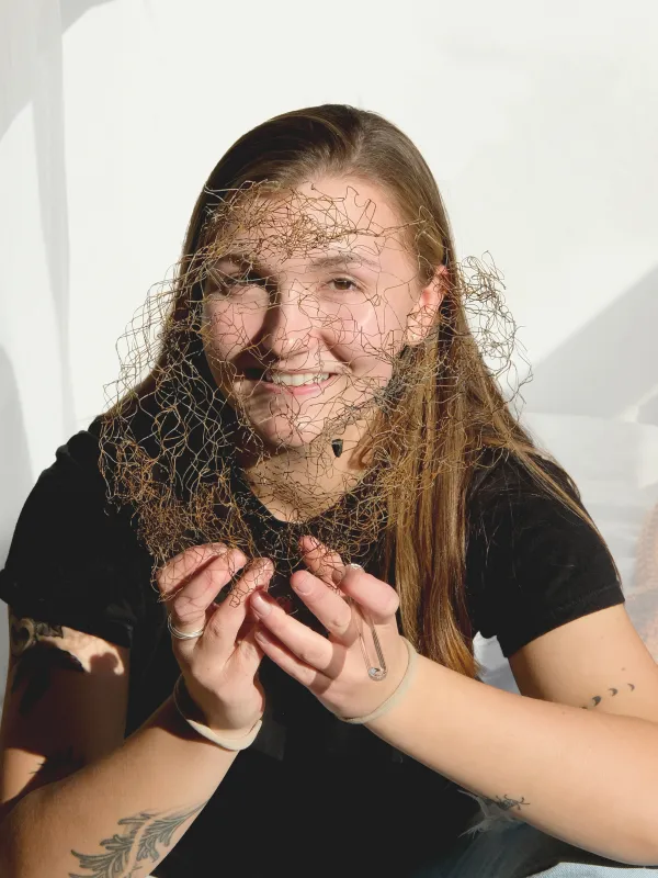 a person behind a mesh screen