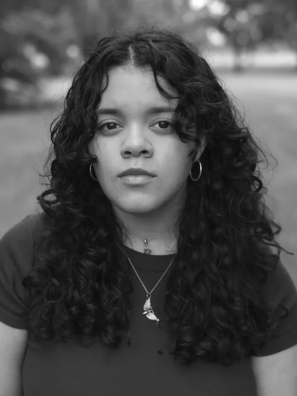 a black and white photo of a person looking into the camera